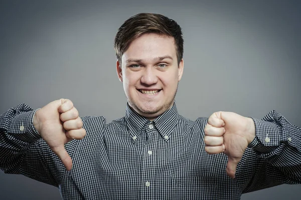 Handsome Young Man Lowered His Fist Thumb Close Portrait Disgruntled — Stock Photo, Image