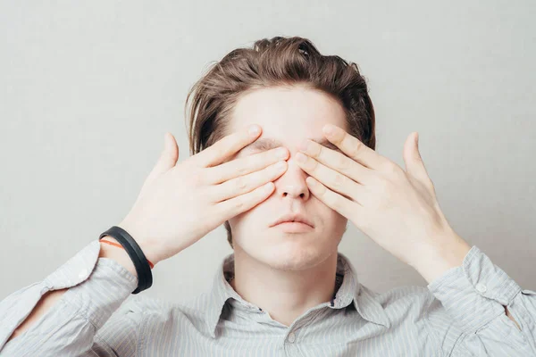 Young Attractive Male Cover Eyes His Hands — Stock Photo, Image
