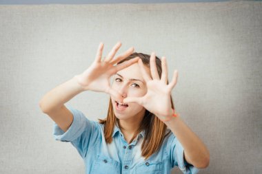 Kadın yüzünü kapatıyor. Gri arkaplanda izole