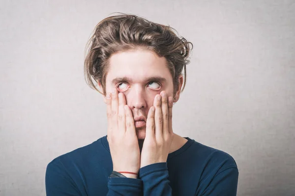 Man Pulls Skin Eyes Gray Background — Stock Photo, Image