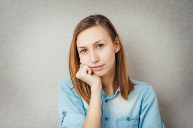 Kız kafasını eline dayadı.