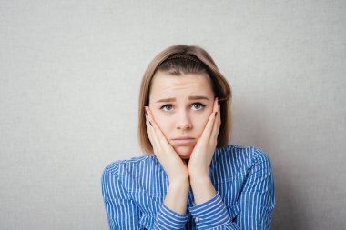 Hüsrana uğramış kadın. Gri arkaplanda izole.