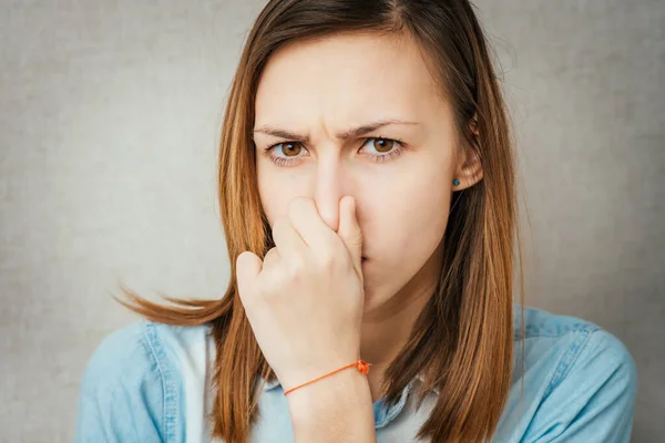 Girl Stinks Closes Nose — Stock Photo, Image