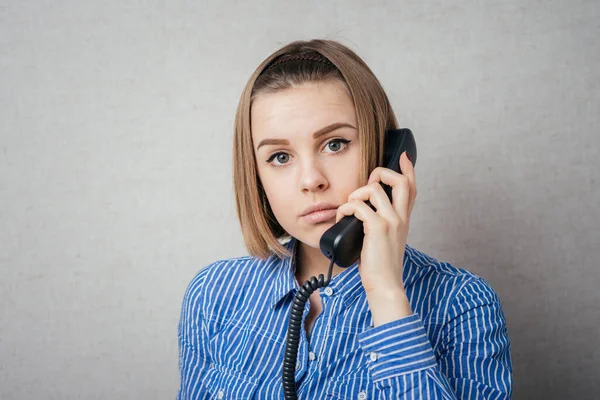 girl talking on landline phone