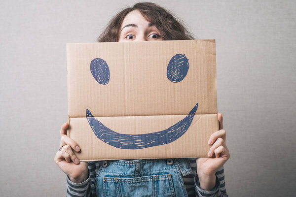 girl holding a happy smiley