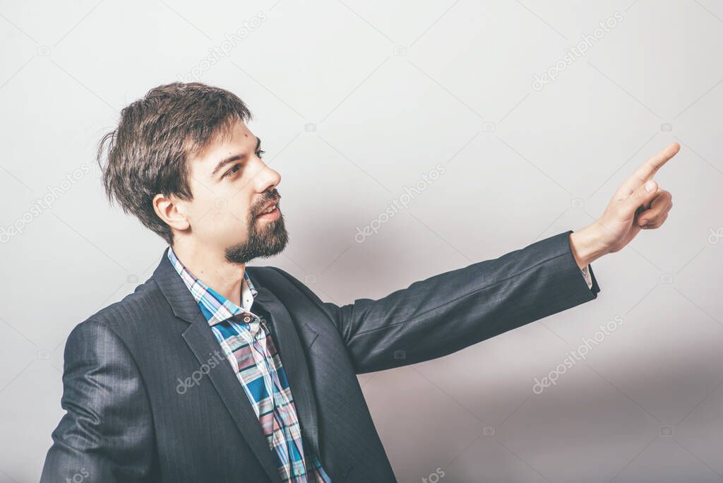 man shows someone on grey background