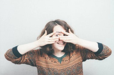 Kız parmaklarından bakıyor