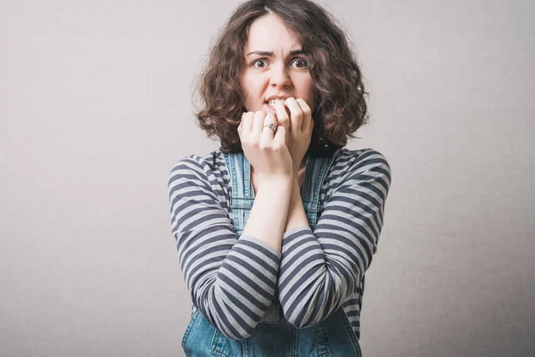 Woman Bites His Nails Experiences Fear Gray Background — Stock Photo, Image