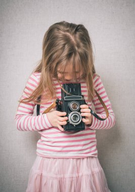  Klasik kamerayla fotoğraf çeken küçük bir kız.