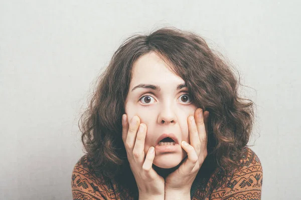 woman in shock against studio background