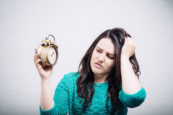 woman holding alarm clock