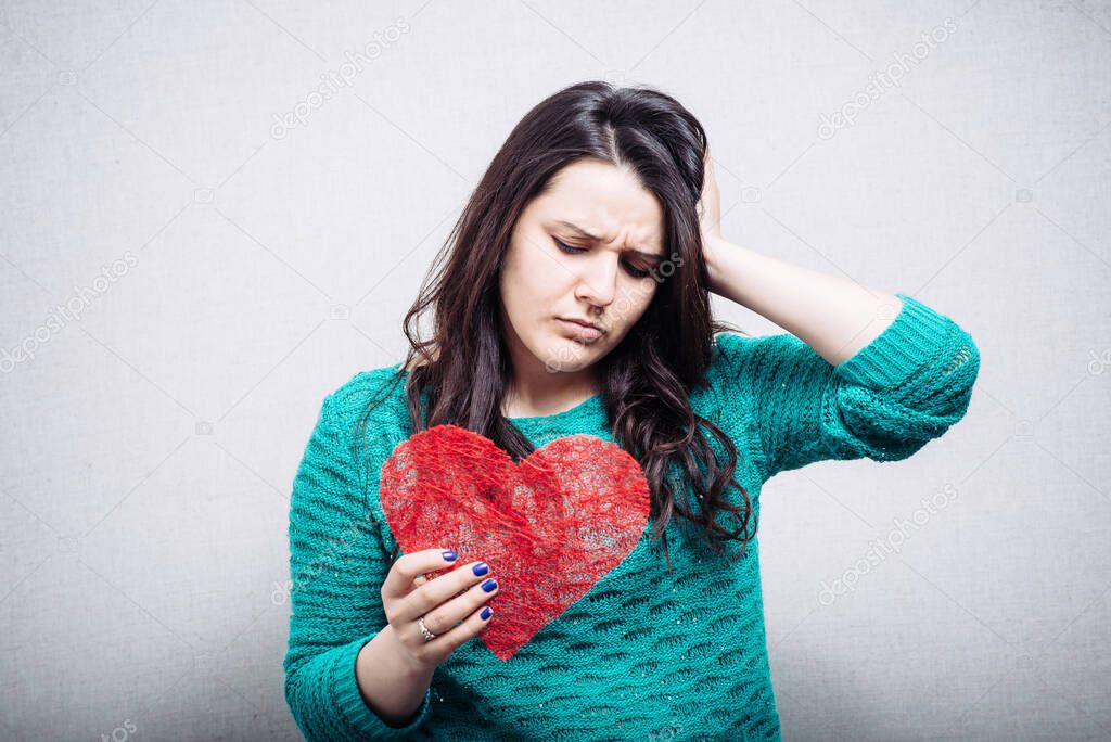 girl holding a toy heart