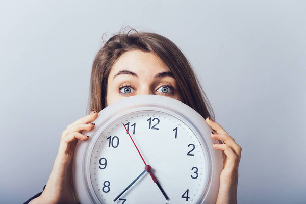 girl with the clock on a gray background