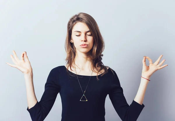 Kız Gri Bir Arka Plan Üzerinde Meditasyon Yapıyor — Stok fotoğraf
