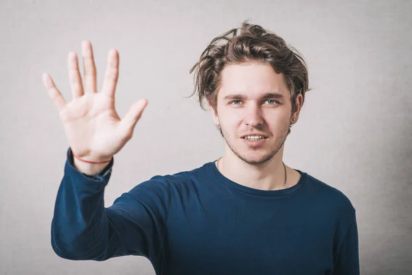Man Shows His Hand Hello Gray Background — Stock Photo, Image
