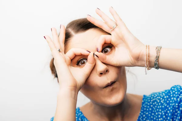 girl shows hands binoculars