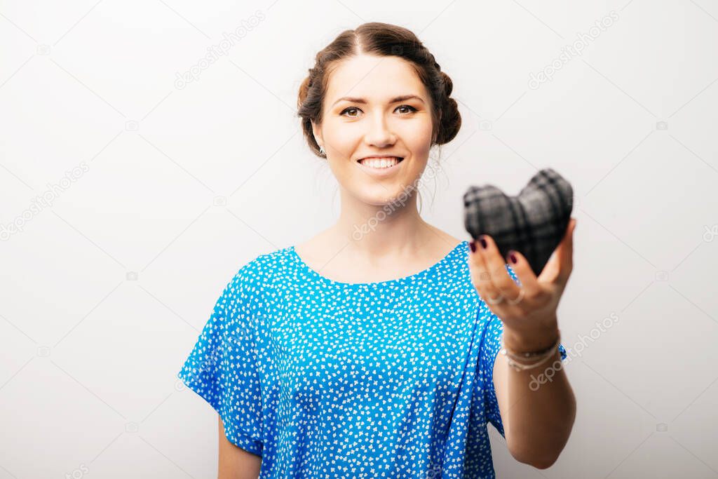 girl holding a toy a little heart