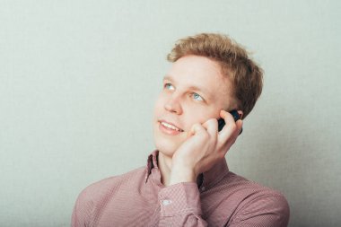 Adam cep telefonuyla konuşuyor.