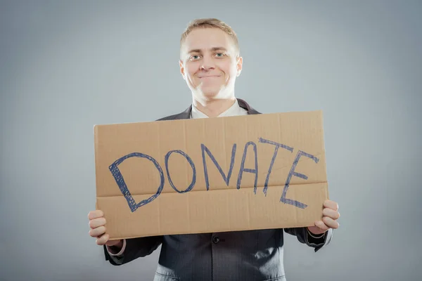 Hombre Sosteniendo Texto Cartón Una Donación — Foto de Stock