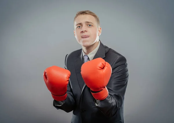businessman in boxing gloves cause to fight isolated