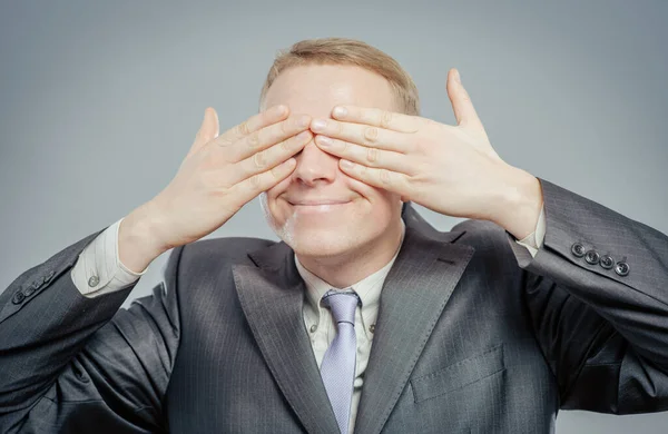 young businessman put his hands over eyes