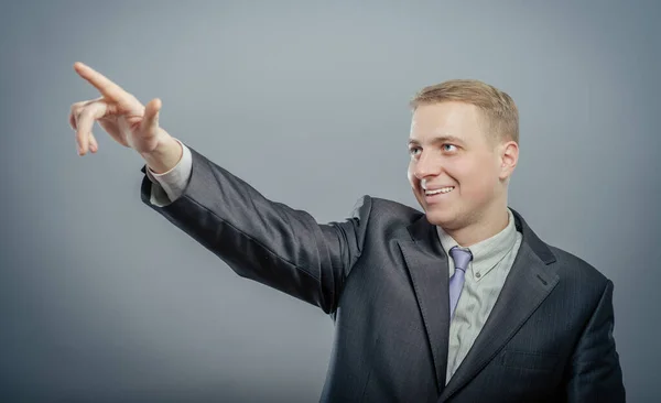 Handsome young business man happy smile point finger to empty copy space, businessman showing pointing up, concept of advertisement product, wear elegant suit and tie