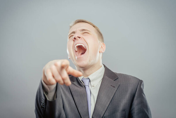 Man in suit  laughing and pointing finger