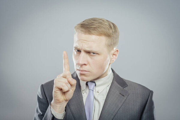 serious man showing attention sign