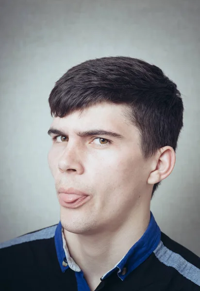 Funny Young Man Shows Tongue — Stock Photo, Image