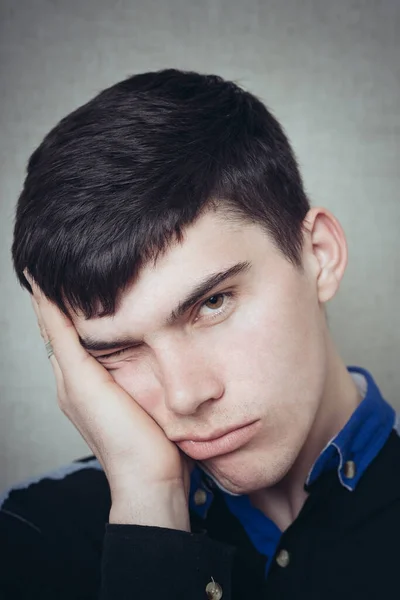 young man posing on grey background