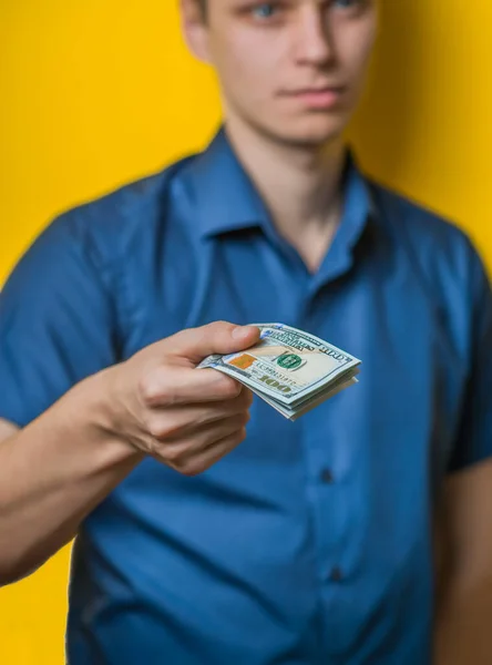 Dollars Young Man Close Blue Shirt Yellow Background Gives Takes — Stock Photo, Image