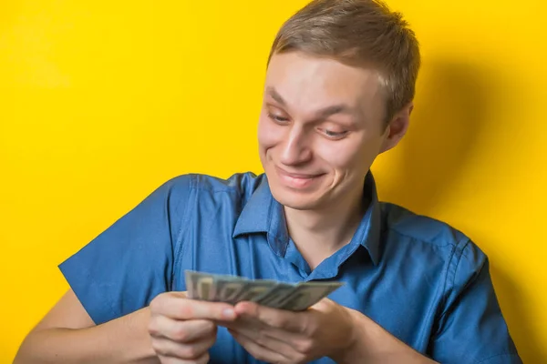 Young Man Close Blue Shirt Yellow Background Counting Money Joy — Stock Photo, Image
