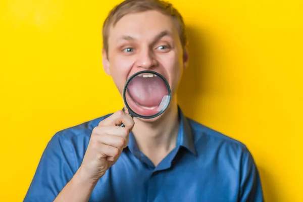 Young Man Close Blue Shirt Yellow Background Holding Magnifying Glass — Stock Photo, Image