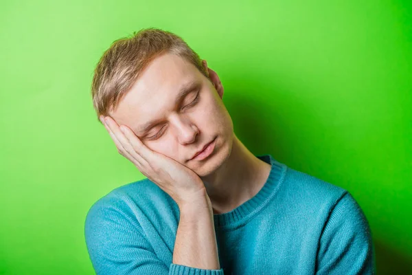 Young Man Dozing Green Background — Stock Photo, Image