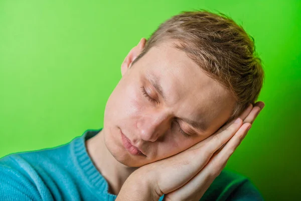 Young Man Dozing Green Background — Stock Photo, Image