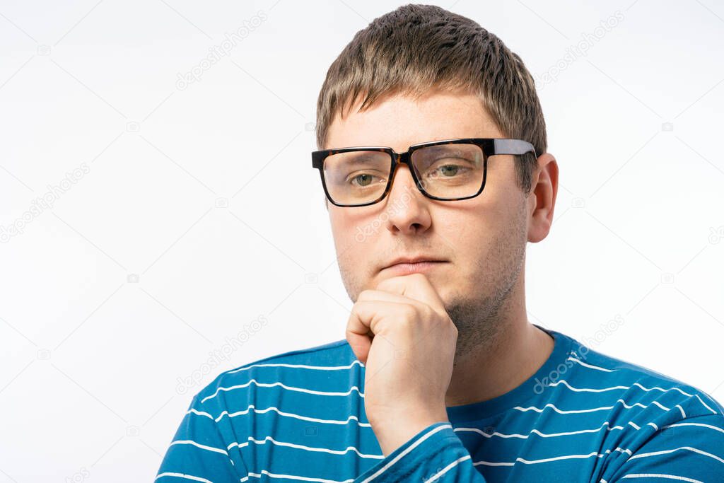 young man with glasses thinking