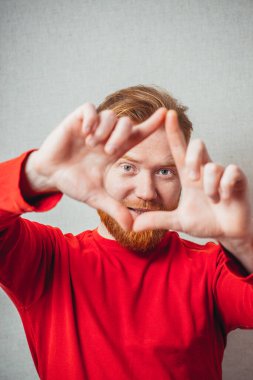 Yüzünü sakallı, yakışıklı, kızıl adamın stüdyo fotoğrafı.