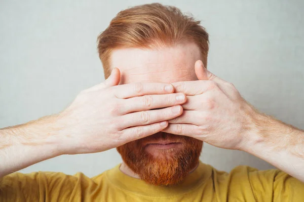 bearded man closes his eyes hands