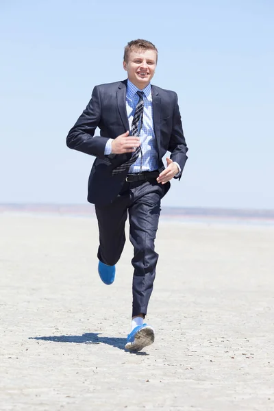 Businessman running in a desert