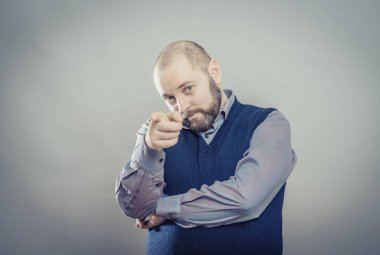 Genç adam parmağıyla birini işaret ediyor.