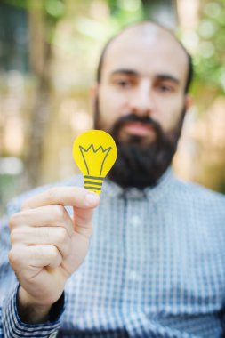 Sakallı adam ampulle düşünüyor.