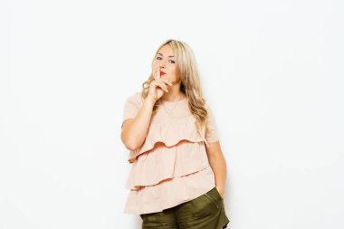 Kadın parmağını dudaklarına koydu.