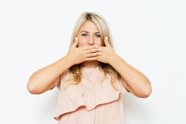 Kız gülüyor ve ağzını kapatıyor.