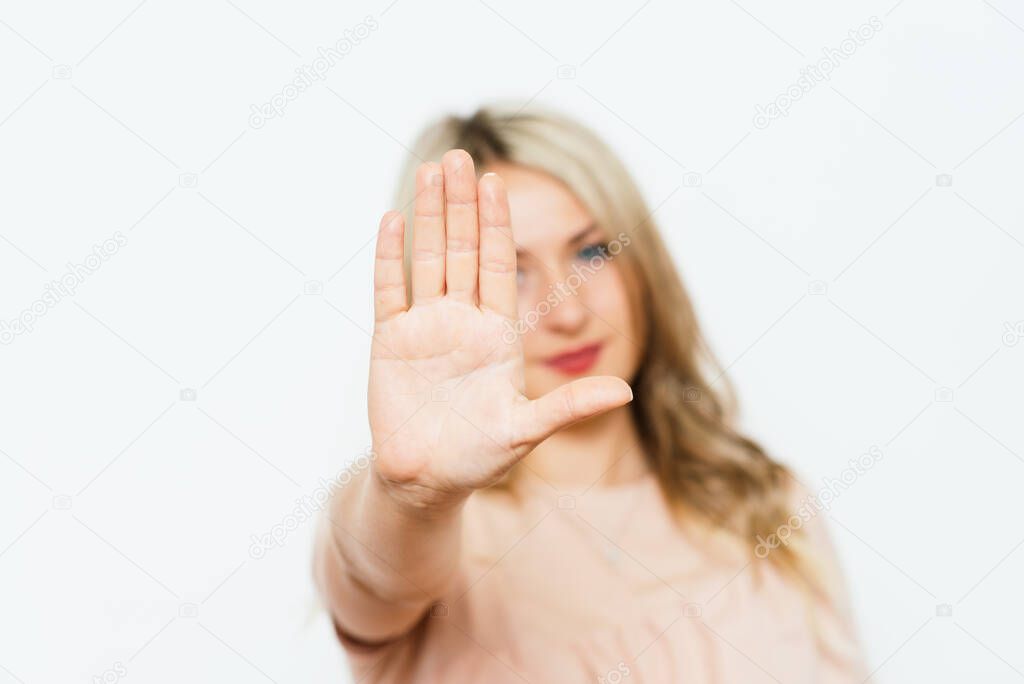 Stop gesture girl against studio background