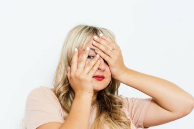 Kadın elini yüzünü kapatıyor.