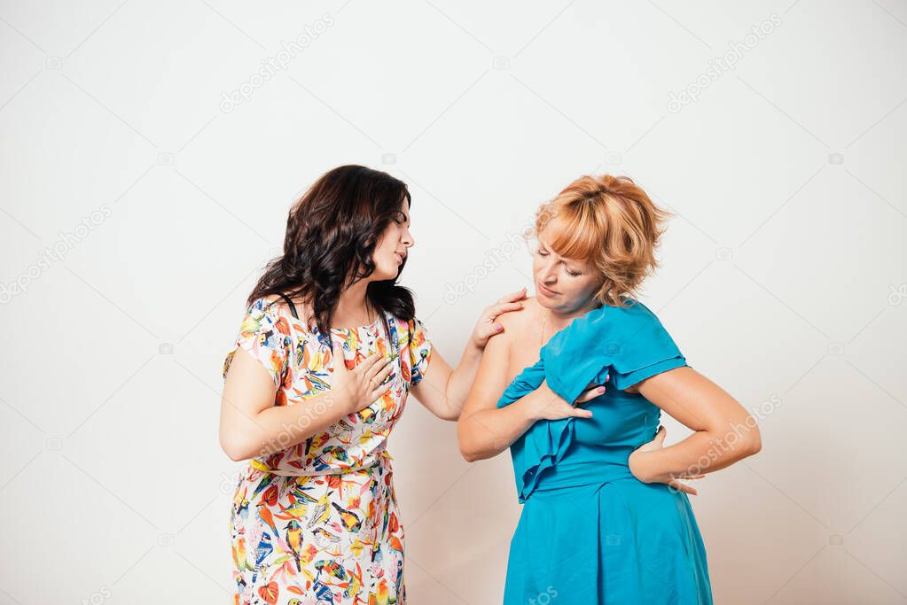 Two women feeling heart pain and holding her chest