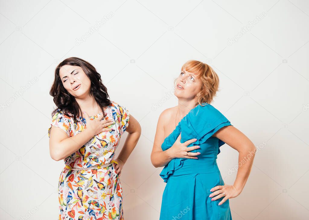 Two women feeling heart pain and holding her chest