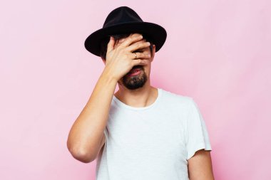  Adam elleriyle yüzünü kapatıyor.