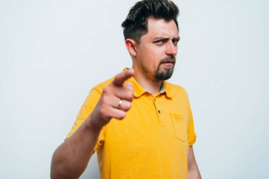 Genç adam işaret parmağını kameraya doğru gösteriyor.