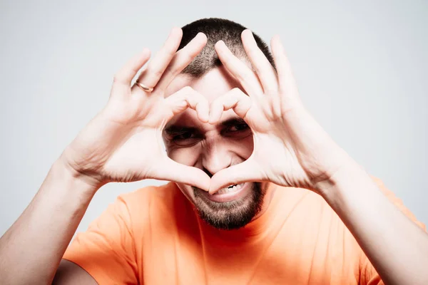 man making a hand heart frame